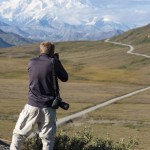 Photographers shooting Denali from outside the park shuttle bus